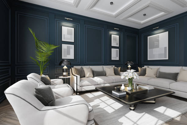 Experience the charm of modern neo-classical Parisian interior design with this luxurious living room setup. The space features classic wall moulding dark royal blue plaster design and large classic windows that flood the room with natural light. The sophisticated white and beige color palette is complemented by plush pillows and sleek modern furniture. A stylish living room table with golden accents and a striking vase filled with white flowers add the finishing touches. This image is ideal for showcasing modern furniture, elegant decor, clean design, cozy room ideas, and renovation projects with a modern classic style.