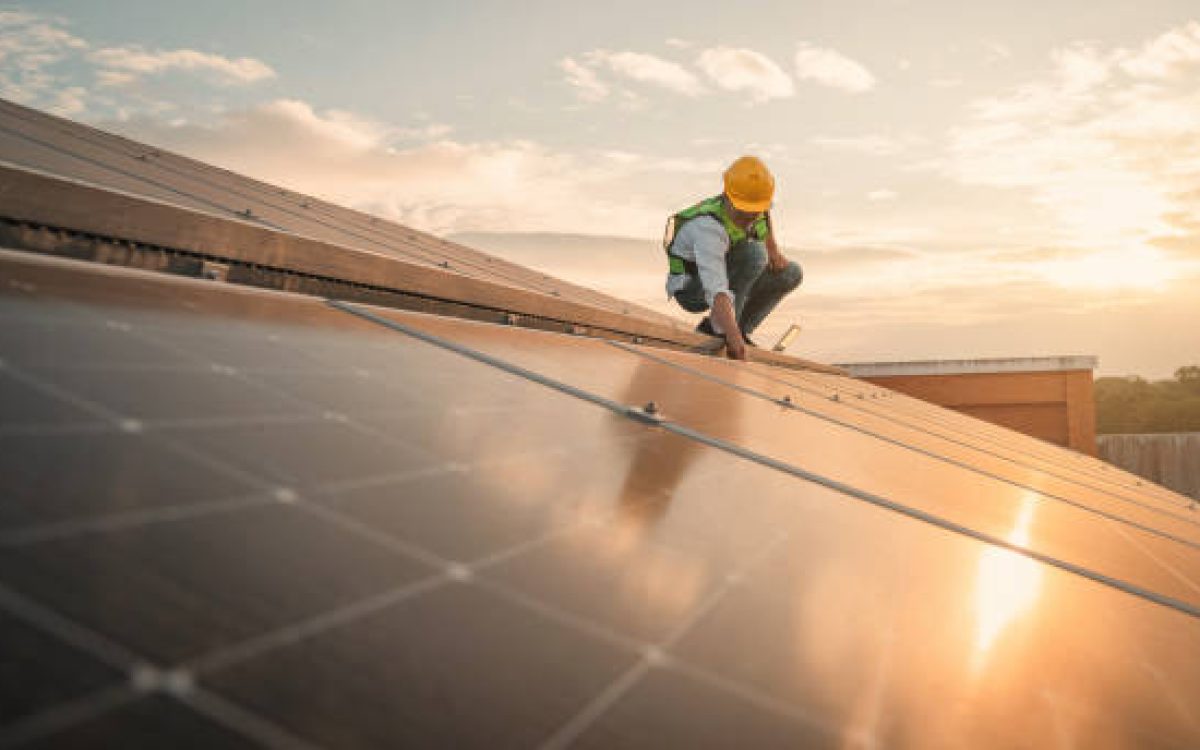 Service engineer checking solar cell on the roof for maintenance if there is a damaged part. Engineer worker install solar panel. Clean energy concept.