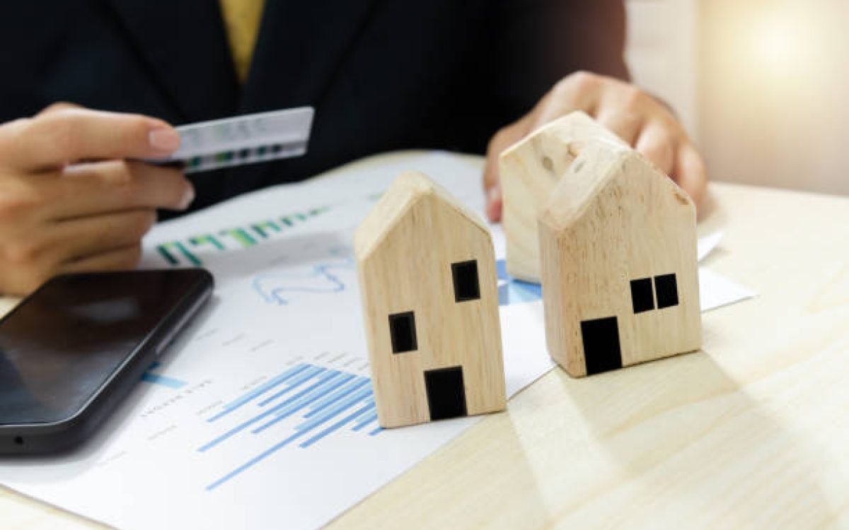 Real estate business profit and loss report business graph.Pay for home bills by credit card.
